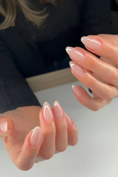 Almond-shaped nails with a glossy sheer pink clean girl manicure.