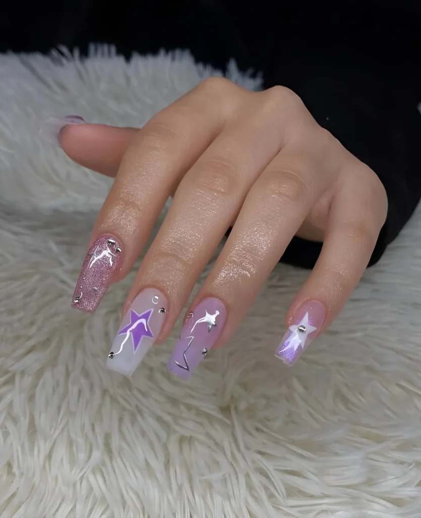 Y2K-style nail art featuring graphic lavender stars, silver chrome lines, and glitter on square nails.