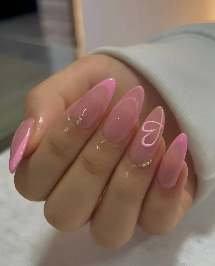 Modern French manicure variations in pink with asymmetrical tips, piped heart design, and rhinestone clusters.
