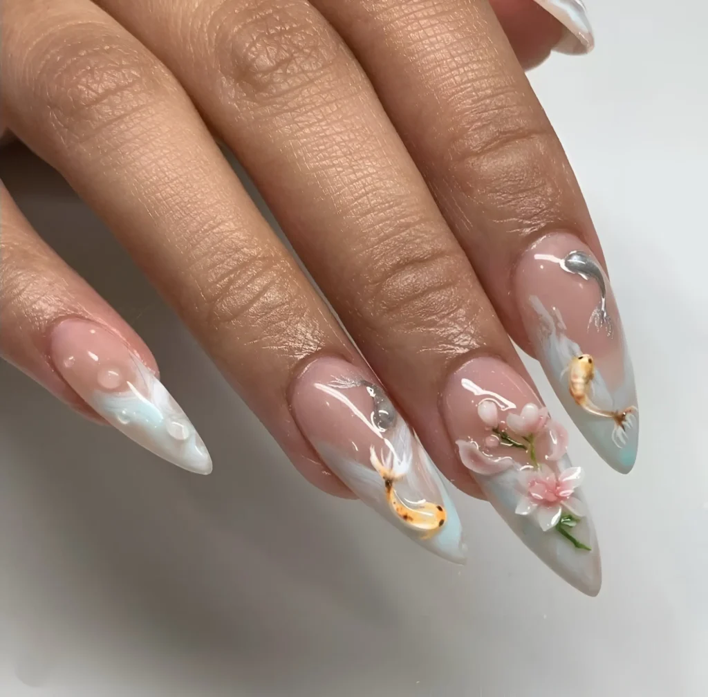 Intricate 3D sculpted koi fish and pink florals on nails with translucent water ripple effects.