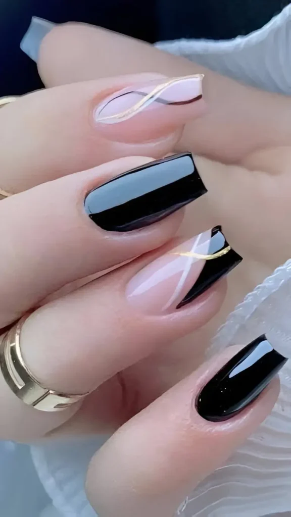 Square nails with a mixed design including solid glossy black and sheer nails with abstract black shapes overlaid with gold and white curved lines.