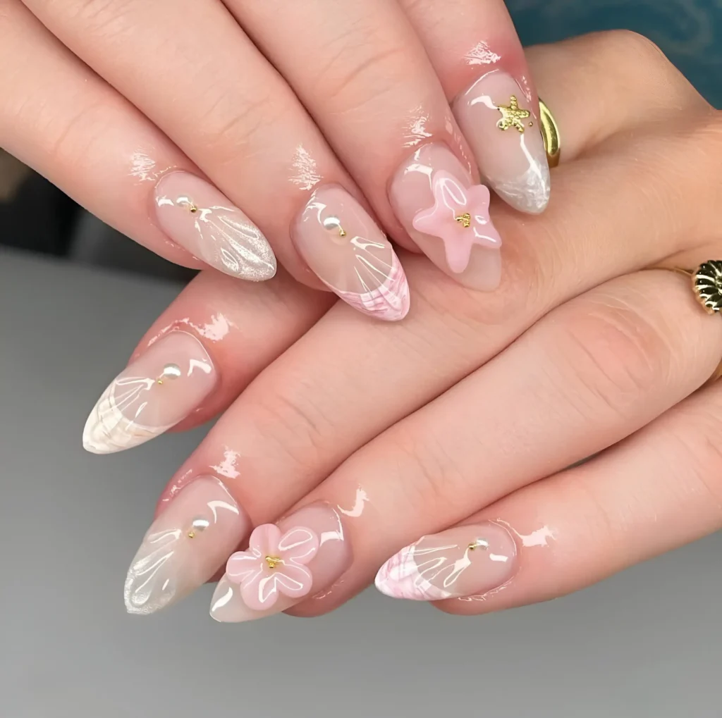 Almond nails with sheer base mixing pink plaid patterns, white 3D textures with pearls, pink 3D starfish/flowers, and a gold starfish charm.