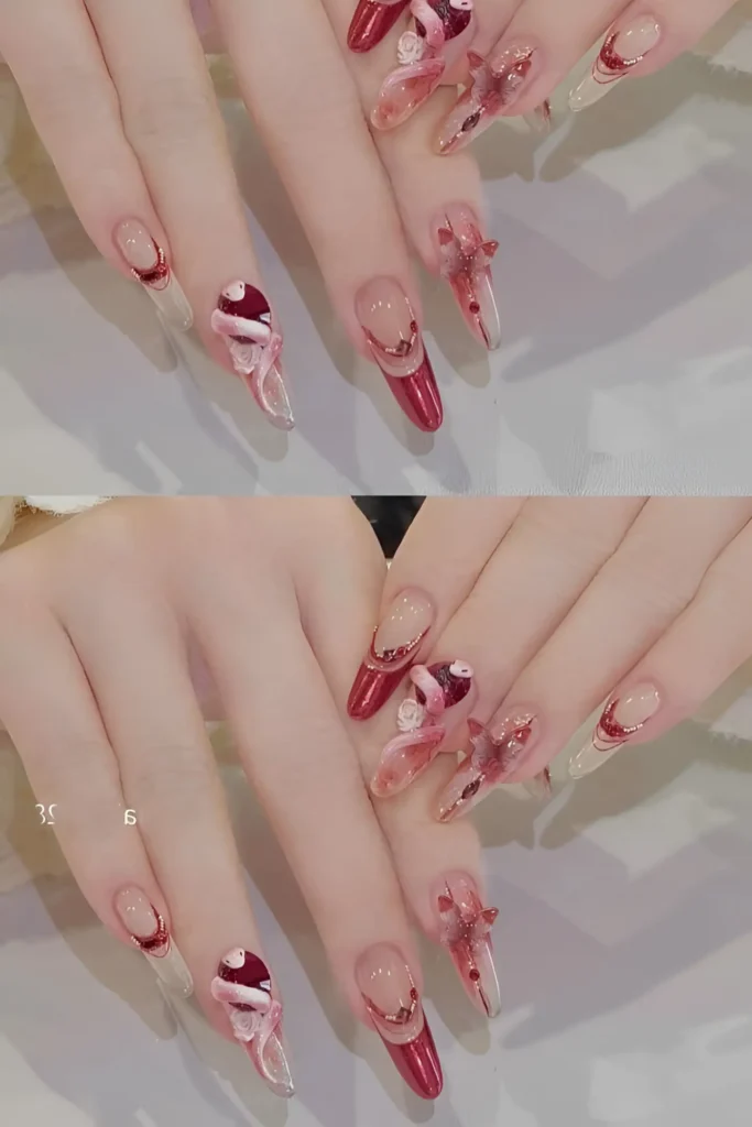 Long stiletto nails with sheer base featuring festive red accents, 3D bows/ribbons, and gold glitter details.