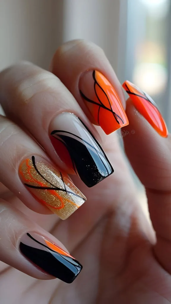 Coffin nails with a mixed abstract design featuring black, orange, and gold glitter sections, color blocking, and intersecting lines on sheer and glitter bases.