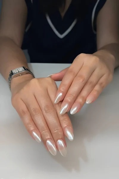 Medium-long almond nails with a full coverage high-shine pearl chrome or glazed finish.