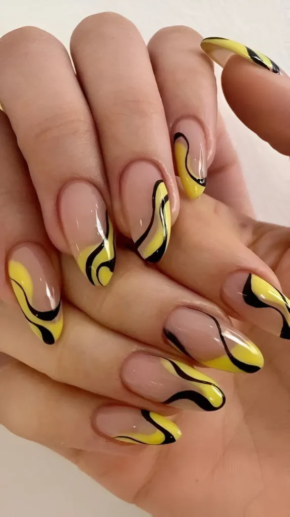 Long almond nails with a sheer base featuring abstract, thick wavy lines/swirls in bright yellow and black, utilizing negative space.