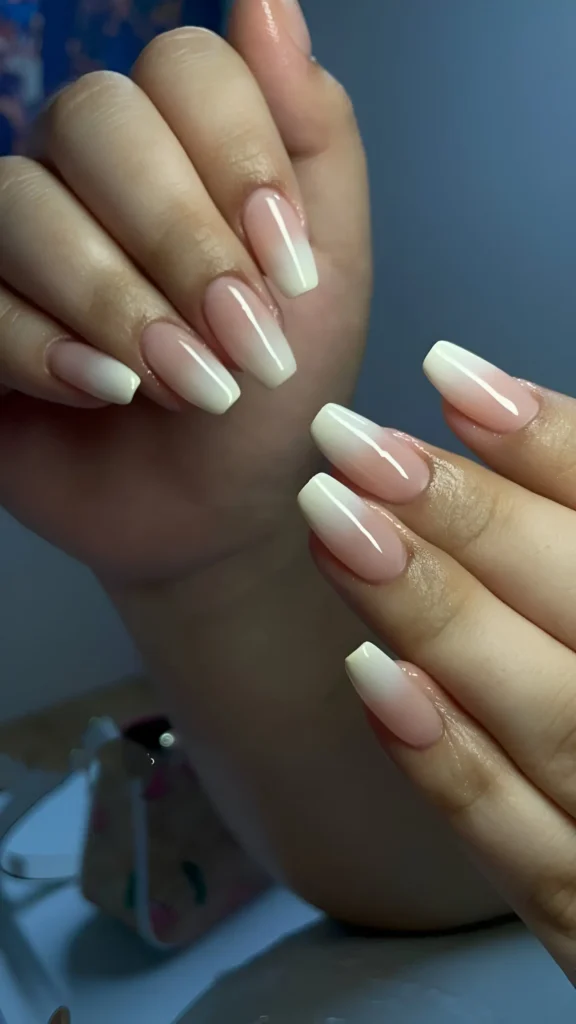 Coffin-shaped nails with a classic pink-to-white ombré gradient, also known as baby boomer nails.