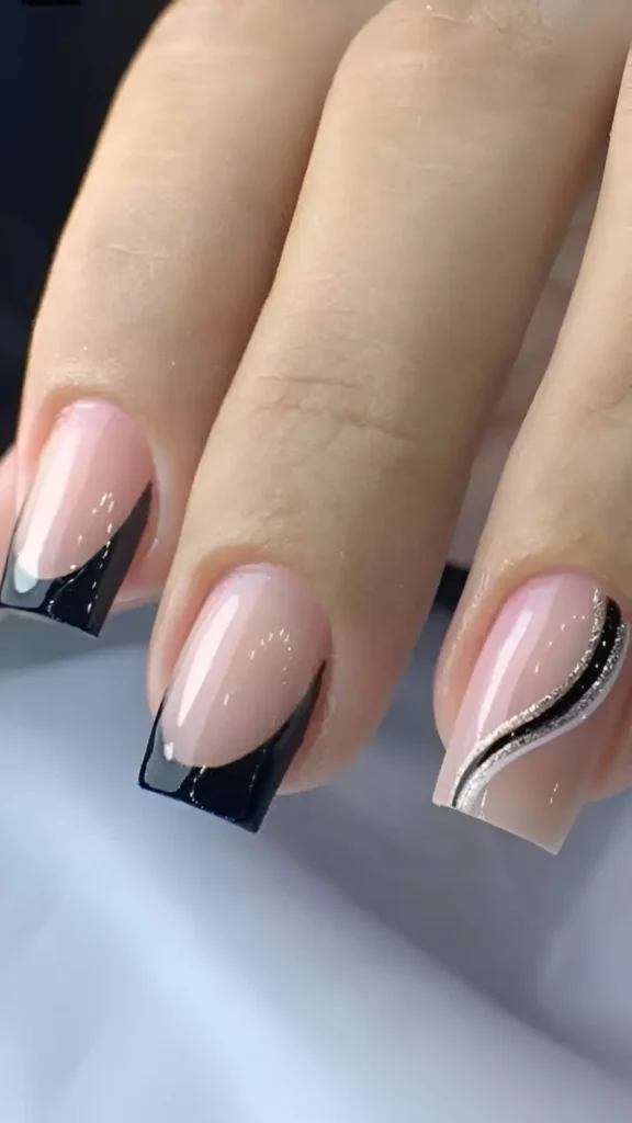 Short square nails with sheer base featuring a mix of angled black French tips and an accent nail with a black swirl and silver glitter line.