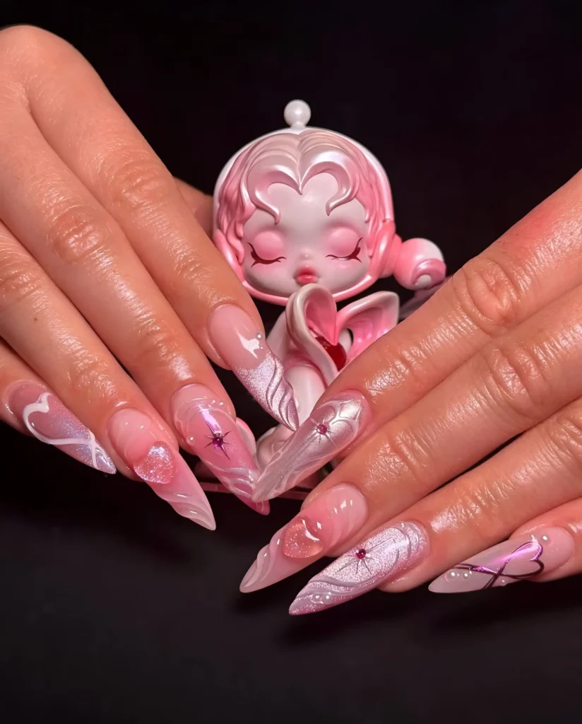 Magical girl anime inspired nails with 3D sculpted ribbons and hearts in pearlescent pink/white and large gem accents.