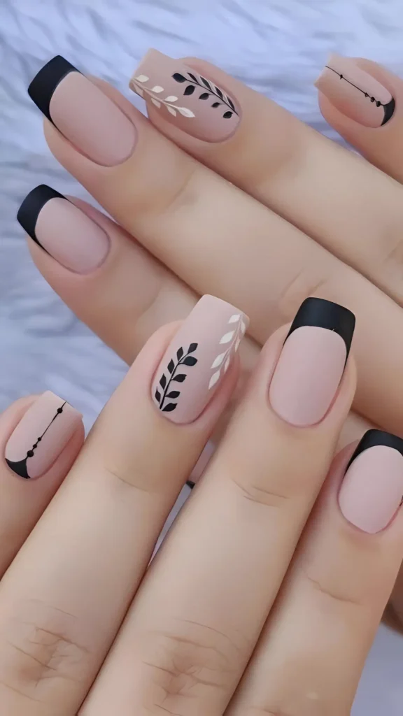 Square nails with a matte dusty pink base featuring mixed designs: matte black French tips, black and white botanical illustrations, and minimalist line art.