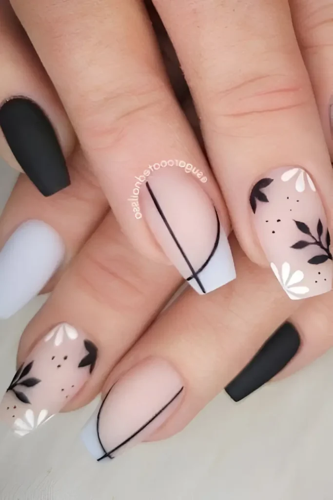 Coffin nails with a mixed matte design: solid black and grey, sheer nails with black and white botanicals, and sheer nails with geometric lines/tips.