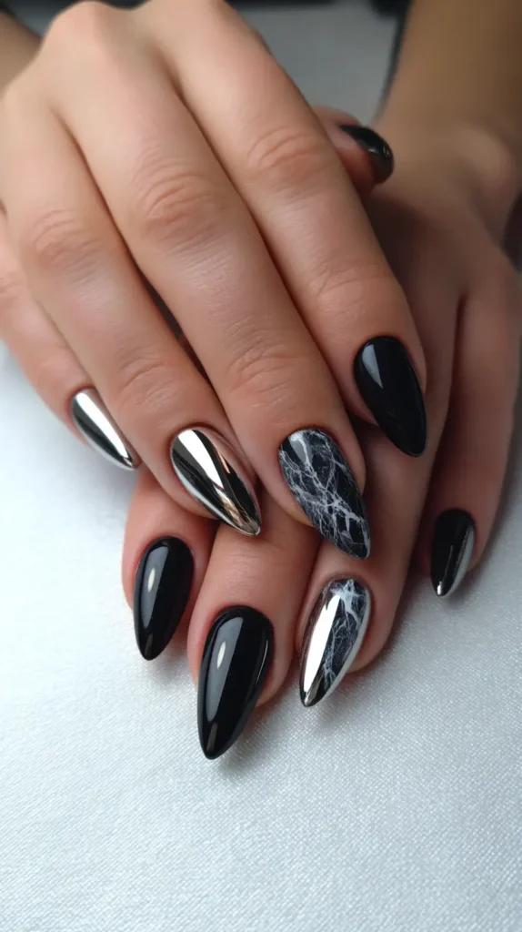 Almond nails with a mixed design including glossy black, metallic silver chrome, and black marble effect nails.