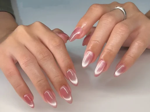 Clean girl nail idea featuring almond nails with a sheer pink base and diagonal silver cat eye effect.