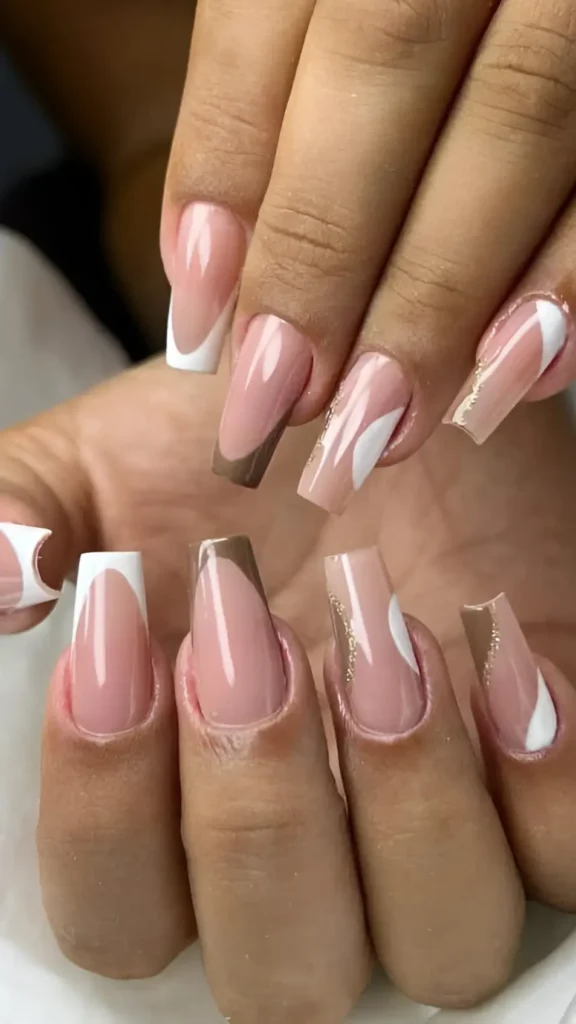 Cute pink base nail design with abstract white and taupe brown curves and gold glitter detail.