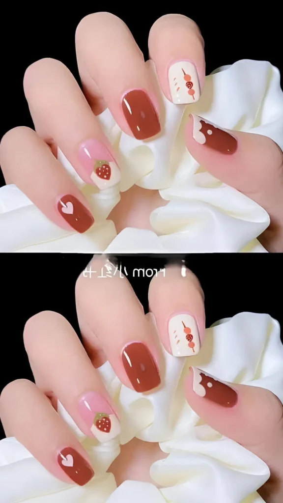 Cute pink, brown, and white mix-match nail art design with strawberry, heart, and abstract details.