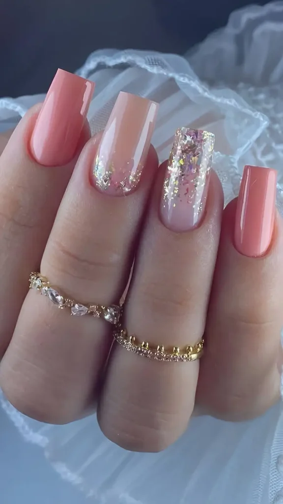 Cute coral pink nail design with chunky iridescent glitter gradient accent nails.