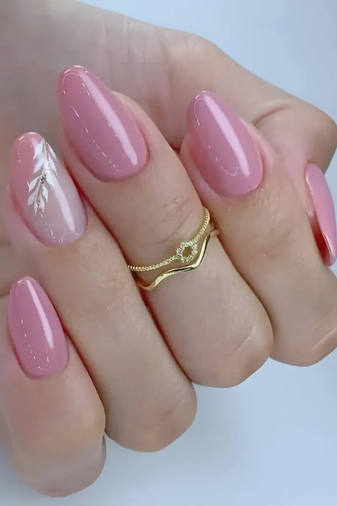 Cute dusty rose pink nail design with sheer accent nail featuring white painted leaf sprig.