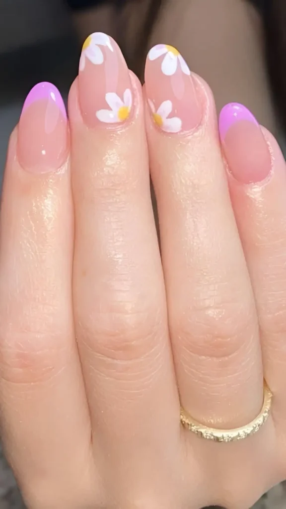 Cute pink sheer base nail design with lavender French tips and white daisy flower accents.