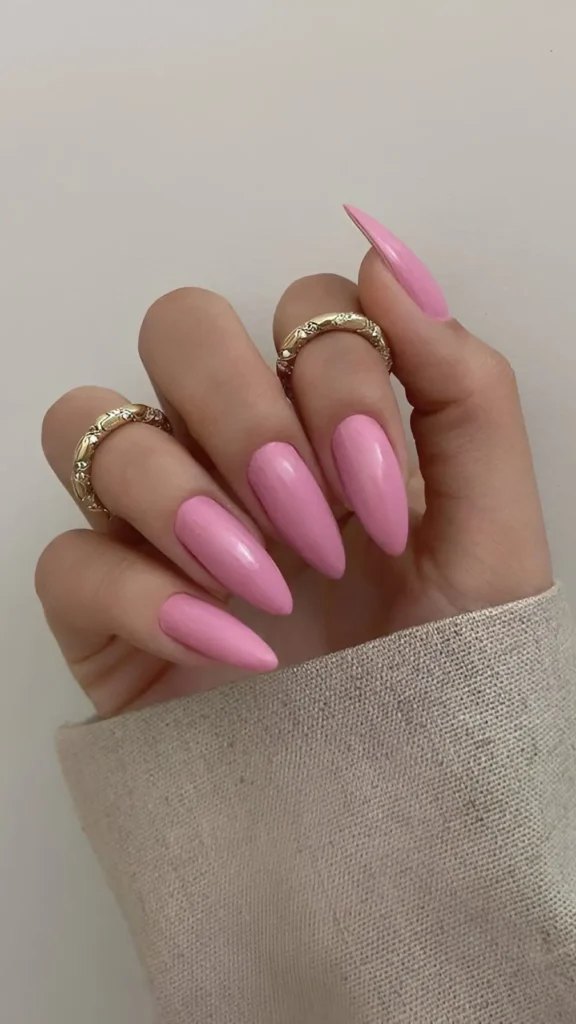 Cute bubblegum pink solid color nail design on long stiletto nails.