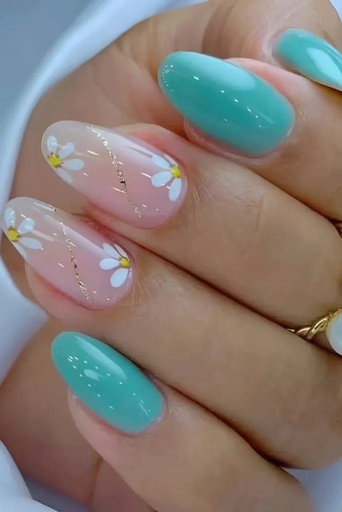 Cute pink and teal green nail design with white daisies and gold glitter swirl accents.