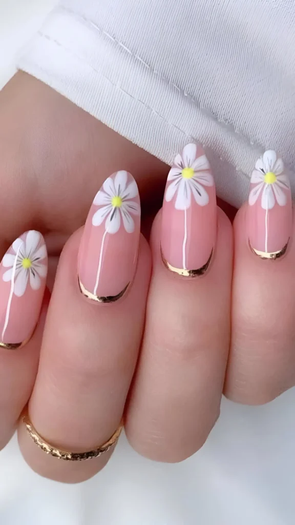 Cute pink nail design with large white daisy flowers and gold metallic cuticle cuffs.