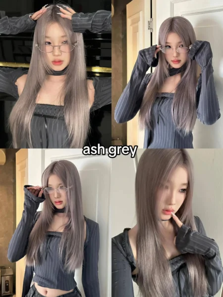 Young woman, possibly of East Asian descent, with long, straight ash grey hair and stylish glasses, showcasing a cool-toned 2025 hair color trend.