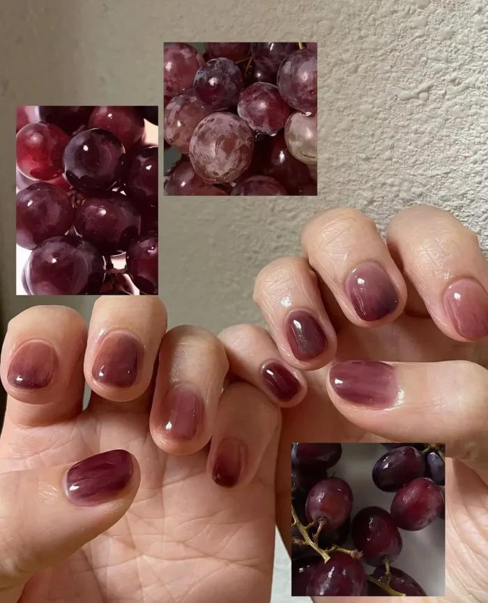 Close up of short, rounded nails with a sheer purple grape ombré effect fading towards the cuticles.