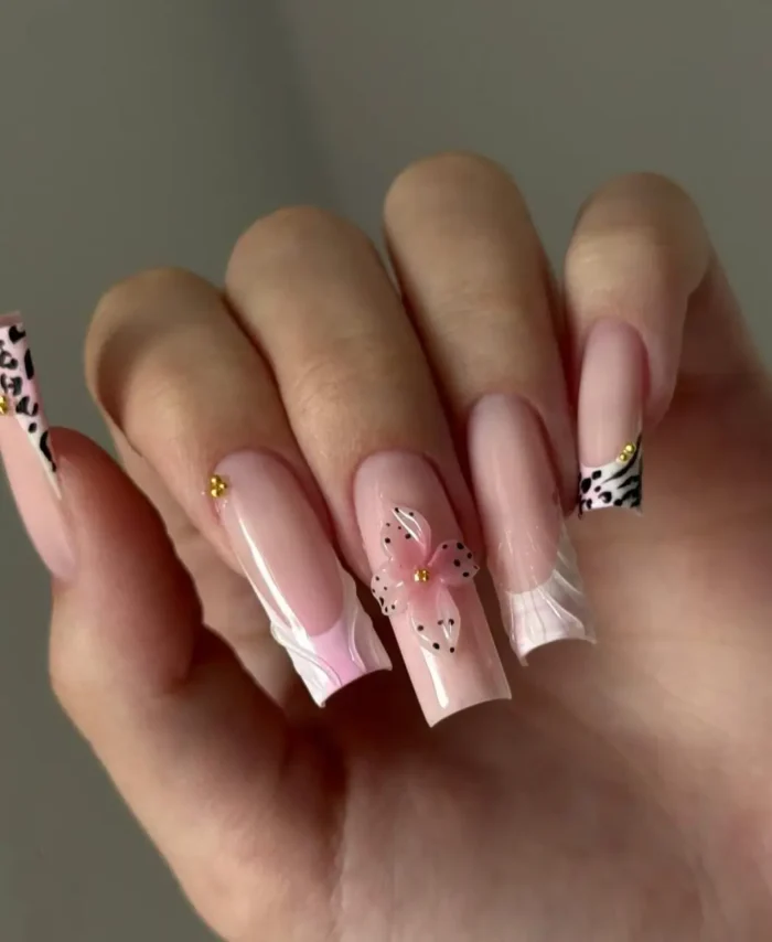 Unique summer nail design on long square nails with white ruffled French tips, zebra print, and a 3D polka dot flower.