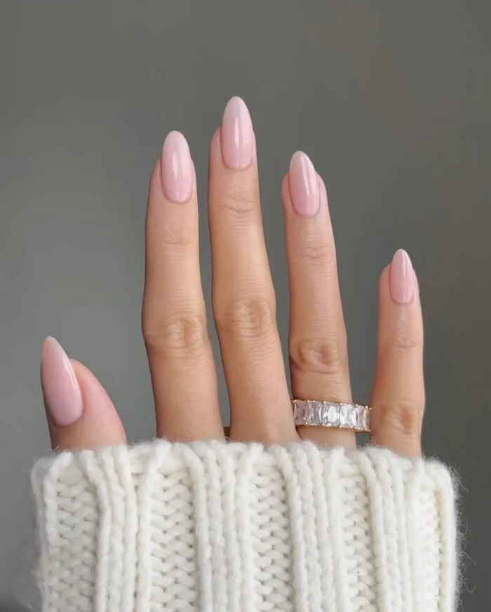 Elegant milky pink gel manicure on medium almond-shaped nails, a cute and simple classic look.