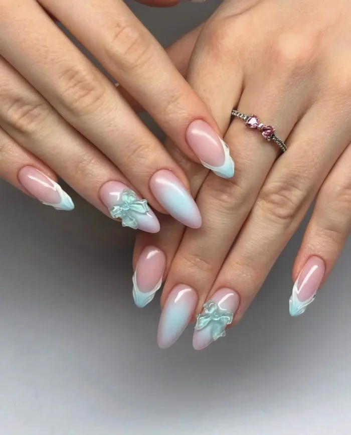Cute almond gel nails with sheer base, mint blue aura, cloud-like French tips, and 3D mint bow accents.