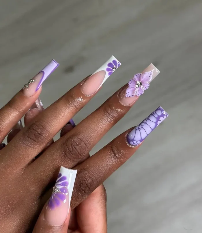 Long coffin nails with a royal purple relief textured nail design, showcasing 3D flowers and intricate patterns.