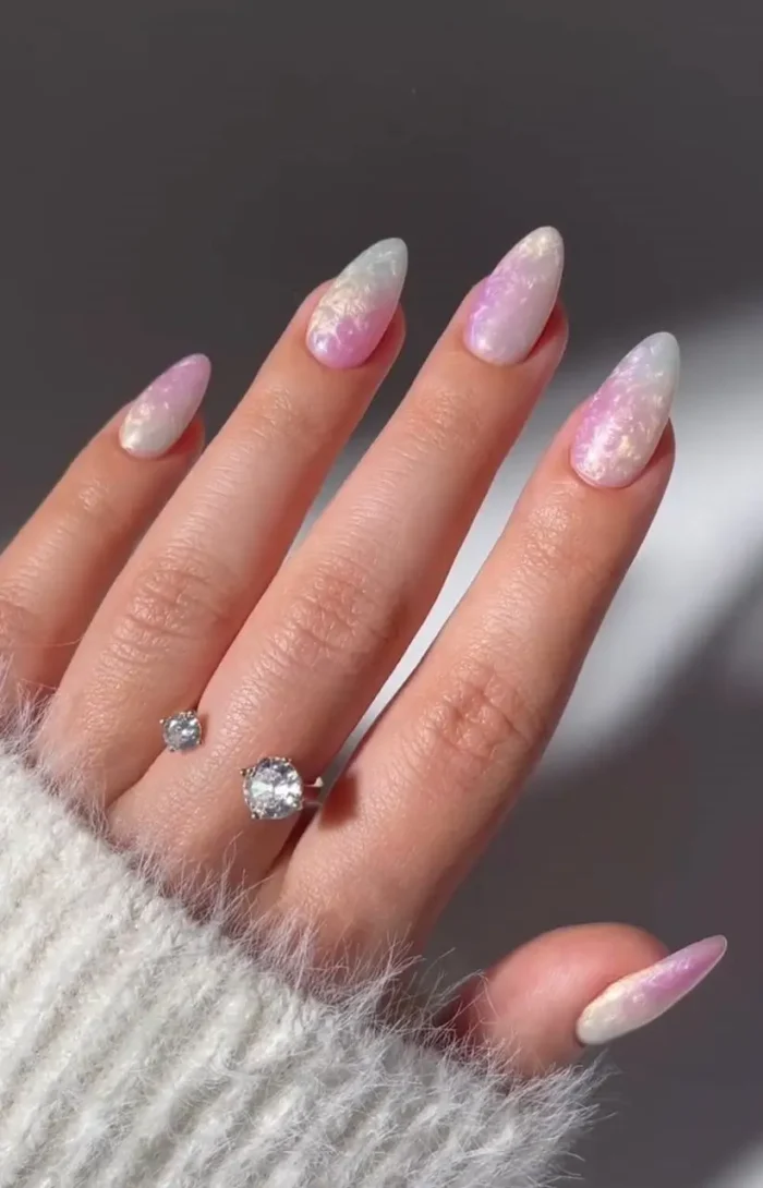 A chic and mesmerizing opalescent manicure with a pearlescent polish that shifts between pink, white, and lavender in the light.
