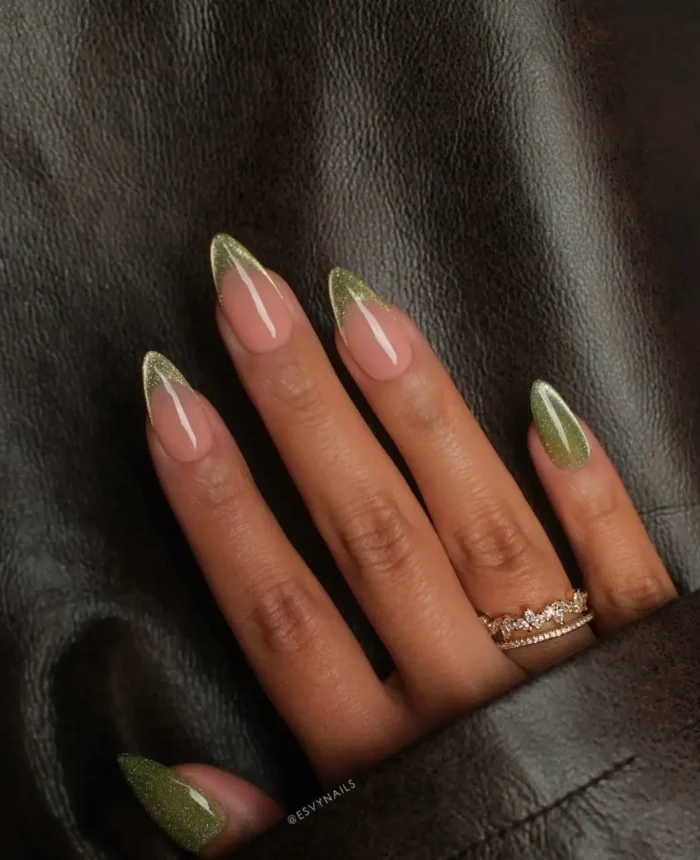 Contemporary French tip nails showcasing a distinctive jade green marble pattern on the white tips.