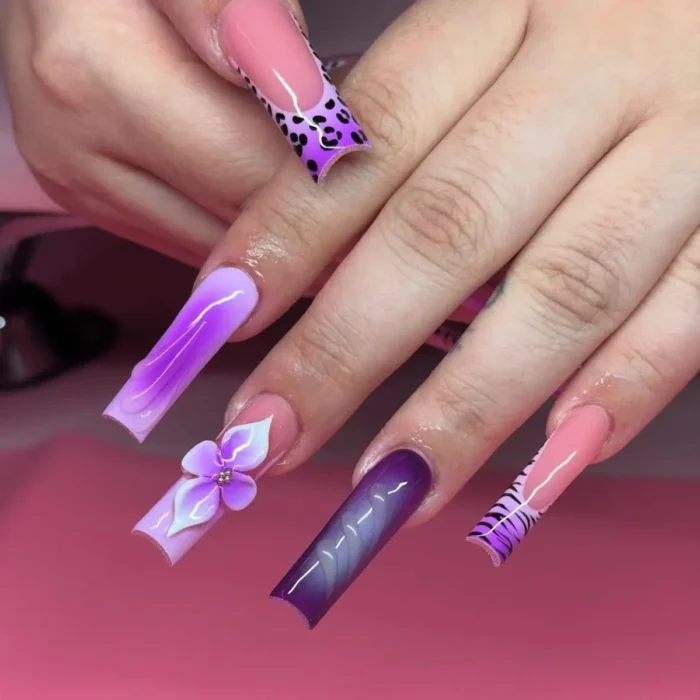 Long square nails with a purple leopard luxe nail design, mixing animal print tips with 3D floral elements.