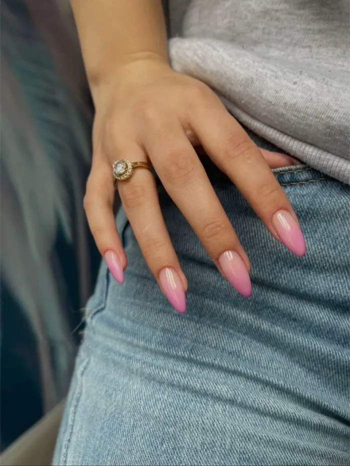 Cute simple gel manicure with a vibrant hot pink aura blush effect on medium-long pointed almond nails.