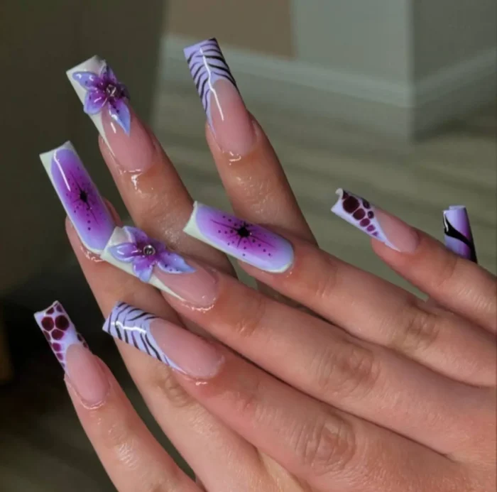 Very long square nails with a jungle orchid tips purple nail design, mixing passionflower art with animal print French tips.