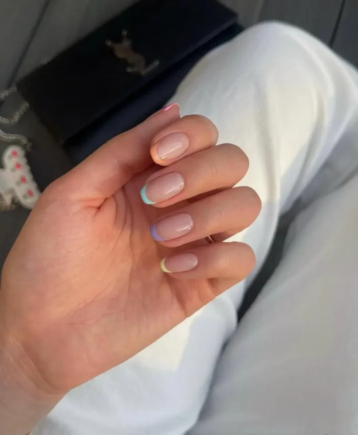 Short, natural nude nails with an ultra-thin white micro French tip, exemplifying minimalist elegance.