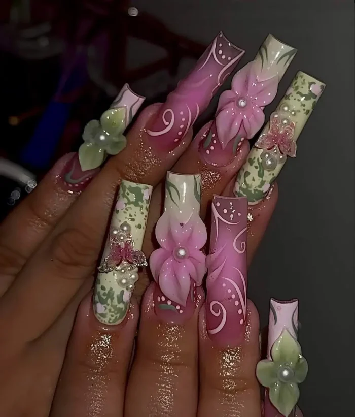 Whimsical very long square nails with an enchanted garden theme, featuring dusty rose and sage green colors, large 3D flowers, pearl accents, and delicate painted swirl details.