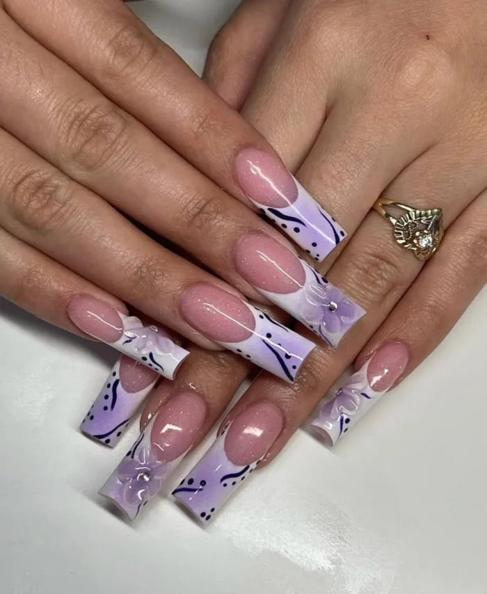 Long square nails with an airbrushed lilac tips purple nail design, featuring abstract lines and 3D translucent florals on a French base.