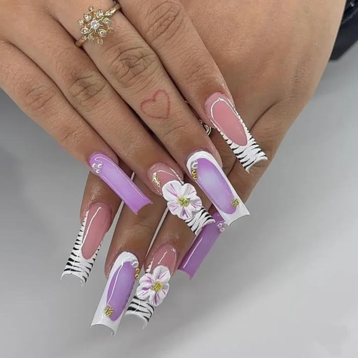 Y2K-inspired long square nails with a wild lilac florals purple nail design, showcasing zebra print, color-blocking, and 3D white flowers.