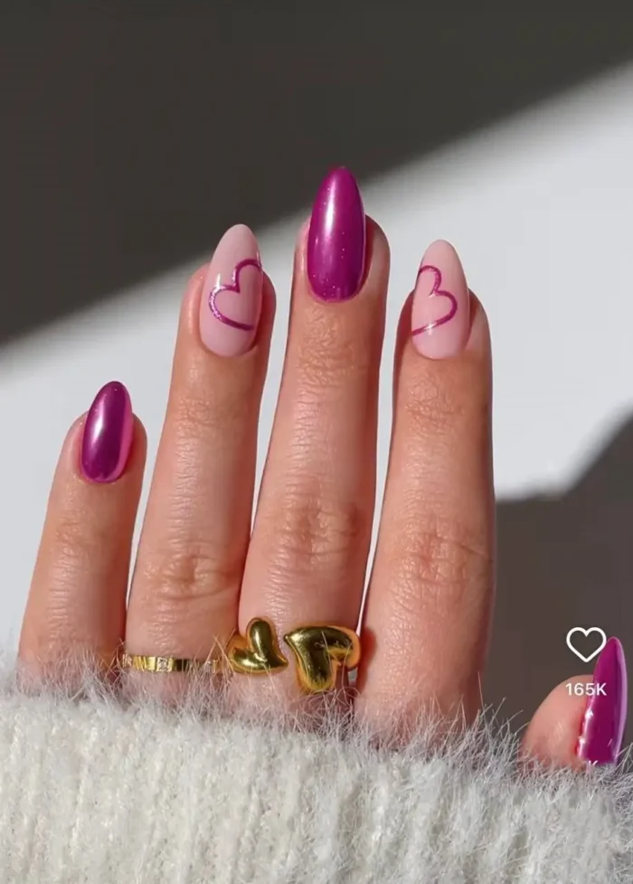 Fashion-forward heart nails with a high-shine fuchsia chrome finish for a bold, graphic, and edgy look.