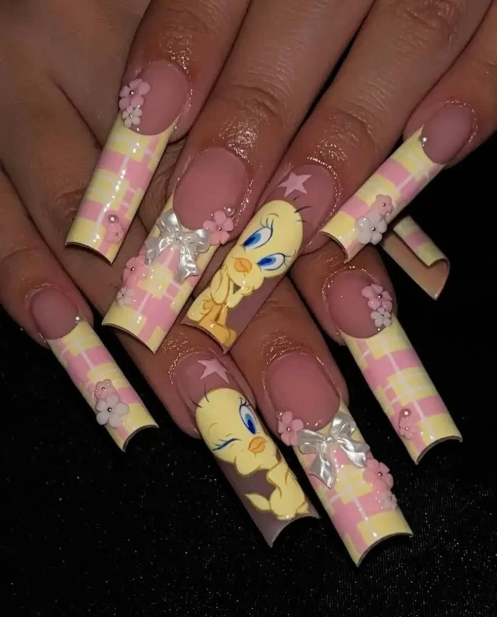 Playful very long square nails with a Tweety Bird theme, showcasing pastel pink and yellow plaid tips, detailed Tweety Bird art, 3D white bows, and tiny pink floral embellishments.