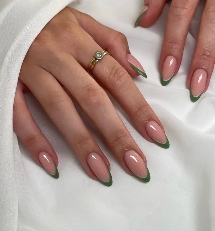 Medium-length almond-shaped nails showcasing a clean and simple French manicure with a solid olive green tip on a sheer natural base.