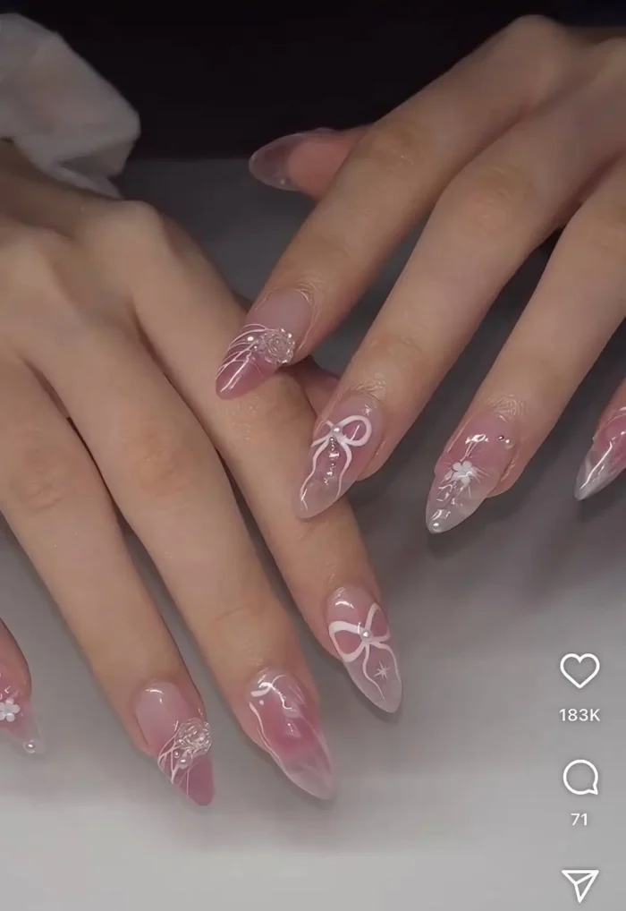 An ethereal and transportive nail art design with delicate 3D florals and fine, thread-like swirls over a soft ombré base.