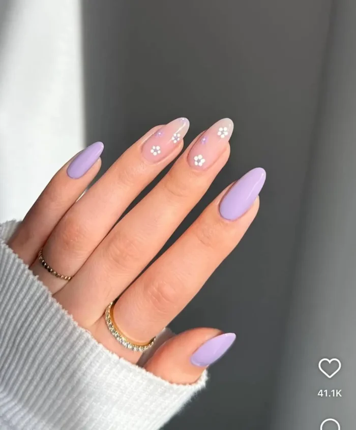 Delicate lavender meadow mani on nails, a soft purple nail design with tiny white floral art for a charming look.