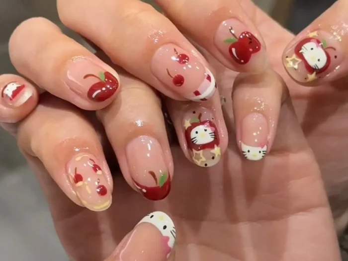 A chic Hello Kitty themed manicure on almond nails, featuring a mix of solid red polish, red polka dots, minimalist character art, and charming 3D red bow embellishments.