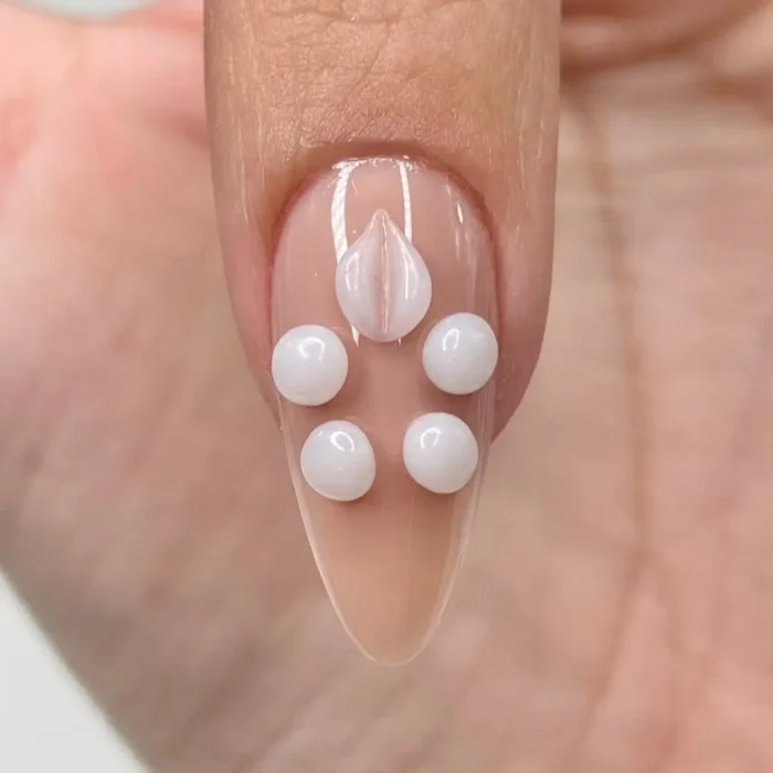 A detailed macro shot of a single, perfectly sculpted 3D nail art petal, showing its refined edges.