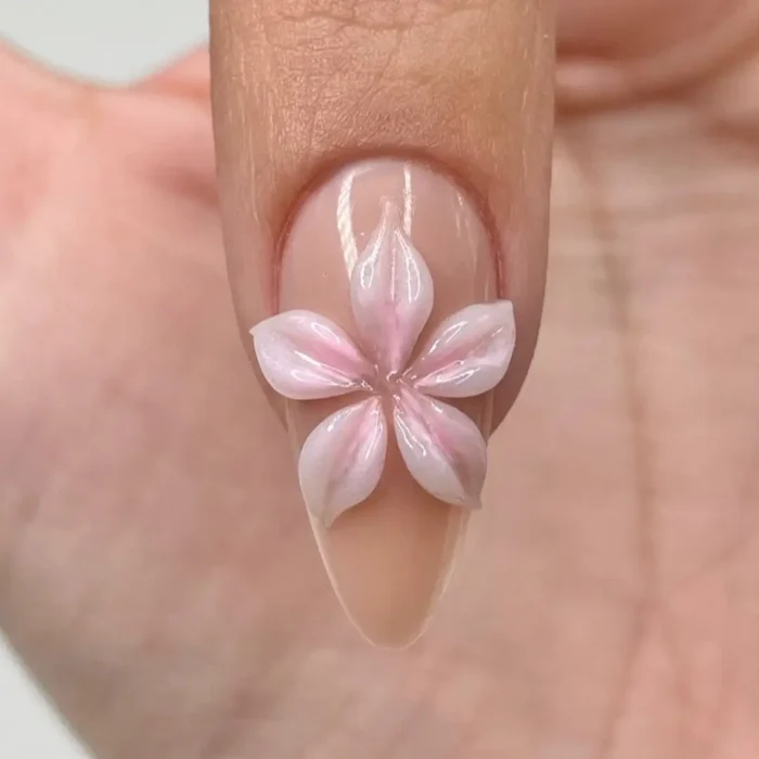 The 3D flower nail after a sheer pink color has been washed over the white petals for a watercolor effect.