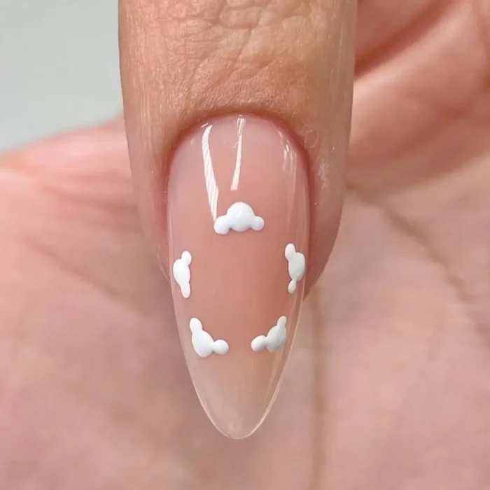 Step two of a hibiscus nail tutorial, showing the white guide dots being connected into soft, cloud-like petal foundations.