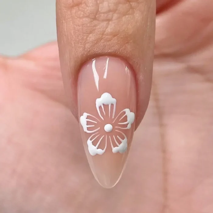 The fifth step in a hibiscus nail art tutorial, where a single white dot is placed in the very center of the flower.